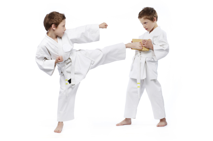 Sparring. Two young girls, teens, Taekwon-do athletes training together isolated over white background. Concept of sport, education, skills, workout, healthy lifestyle and ad. Power and energy.