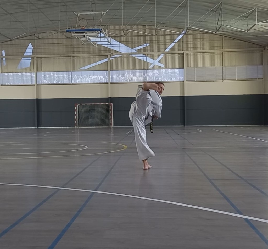 Instructor performing side piercing kick